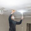 hand sanding of the plasterboard ceiling with a trowel.