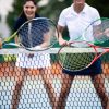 Happy fit people playing tennis together. Sport concept