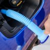 Close up filling of diesel exhaust fluid / AdBlue from canister into the tank of blue car for reduction of air pollution. Environmental or eco friendly solution.