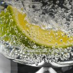 A refreshing slice of lemon submerged in sparkling water