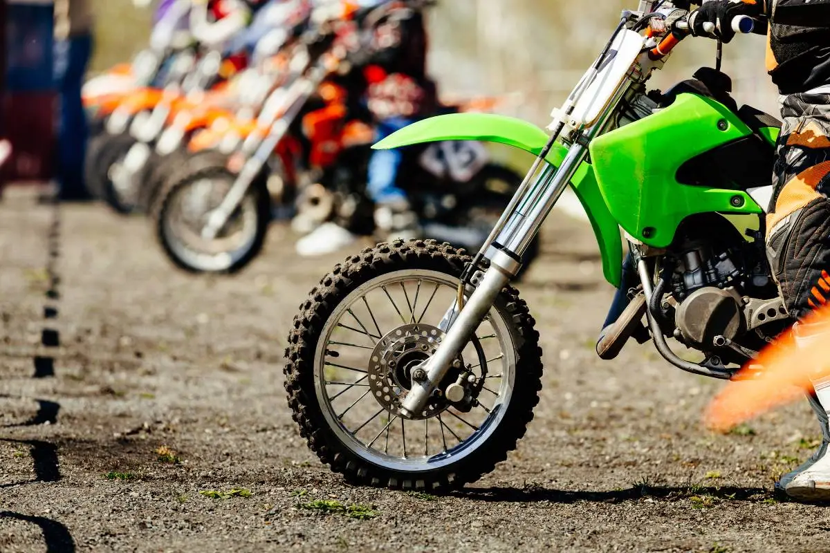 starting line group motocross racers on race track