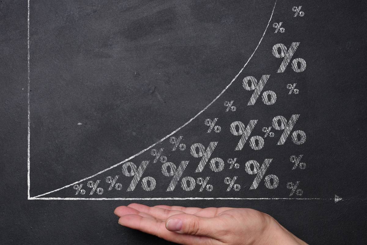 Woman's hand and a graph with growing indicators, income increase, inflation